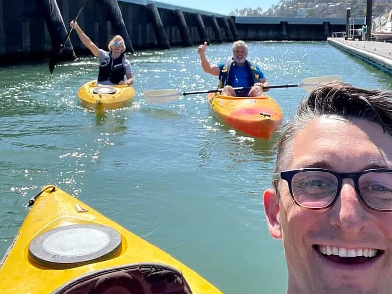 Colleagues kayaking together on a sunny day in Tiburon harbor