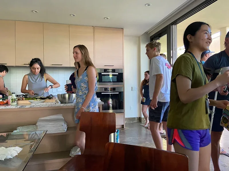 Team members preparing food together in a kitchen during a retreat